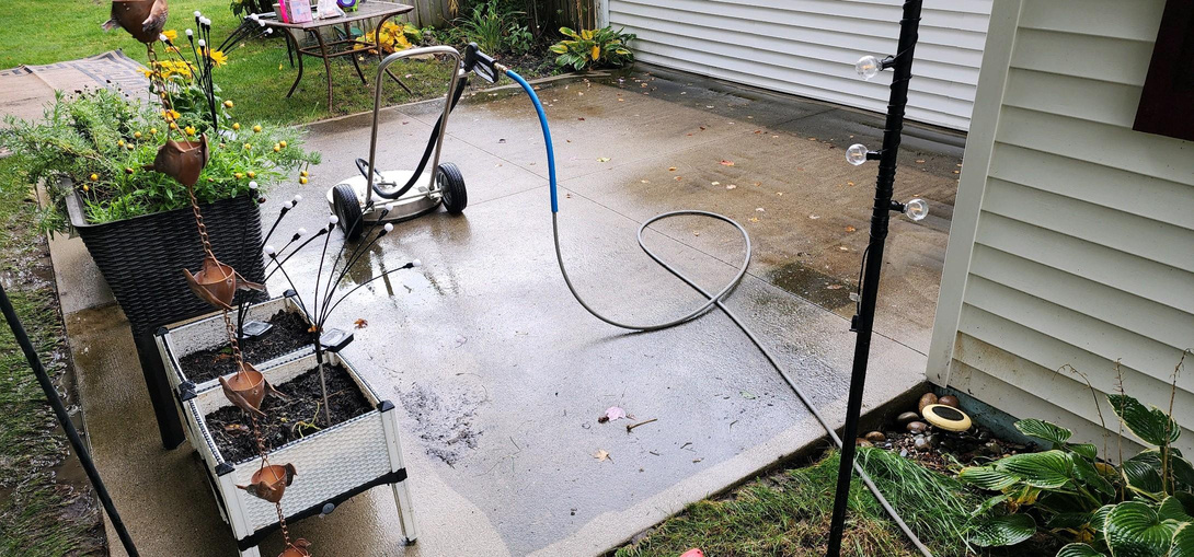 Power washing a concrete patio to help bring it back to life using our mobile power washing unit!